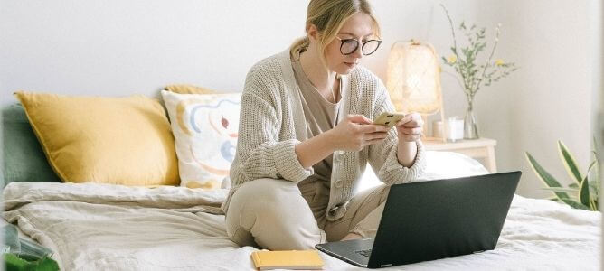Woman studying in bed. Woman studying in bed.