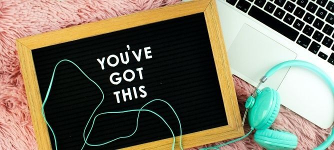 Letter board, headphones, and laptop