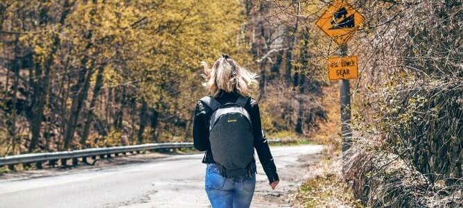 woman walking down a road woman walking down a road