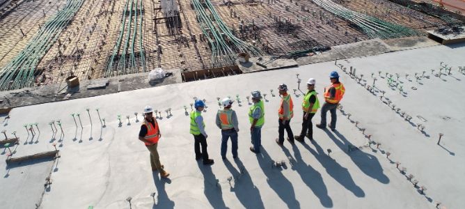 Construction workers surveying the job site.