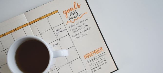 Planner with cup of coffee.