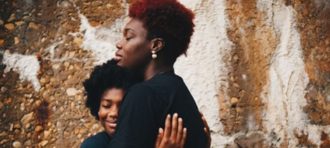 Woman hugging a child.