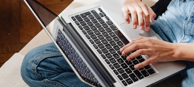 person using laptop on lap.