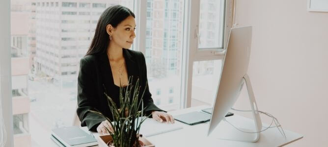 Woman in office looking at computer screen