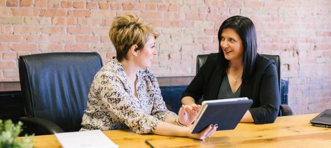 Two women looking at paperwork. Two women looking at paperwork.