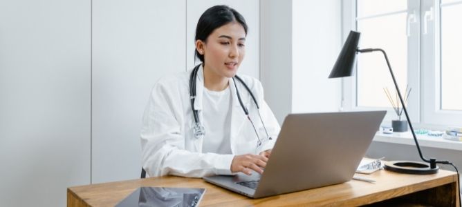 medical professional using laptop. medical professional using laptop.